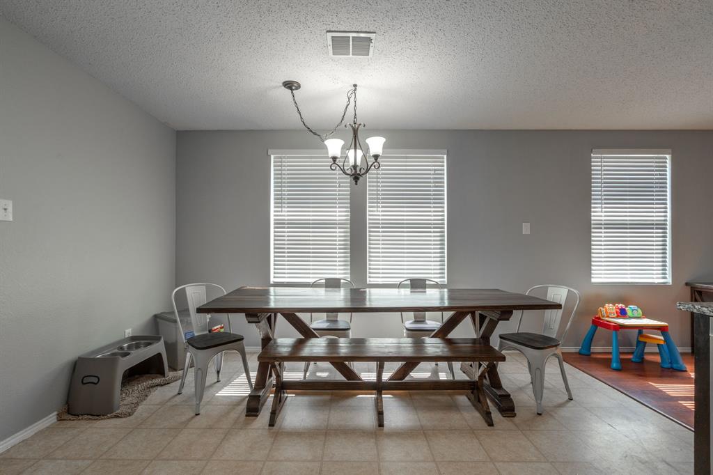 1973 Lariat Drive Fort Worth, TX 76247 - Photo 8 of 28 a view of a dining room with furniture and a chandelier