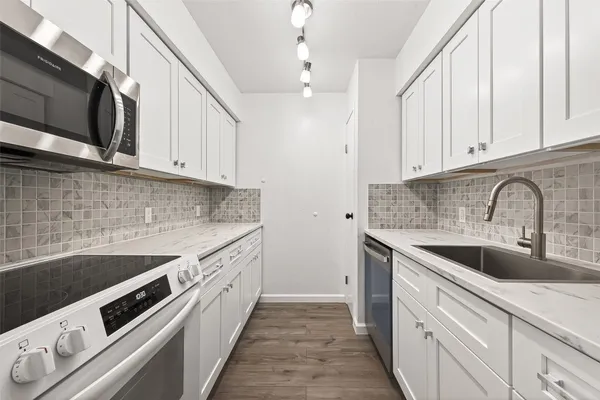 a kitchen with a sink and cabinets