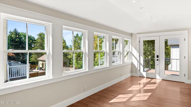 a view of an entryway with wooden floor and garden