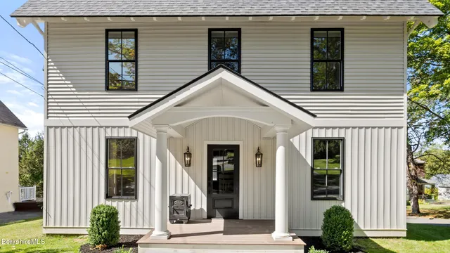 a view of a house with potted plants