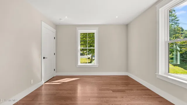 an empty room with window and natural light