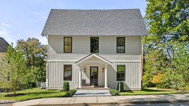 a front view of a house with garden