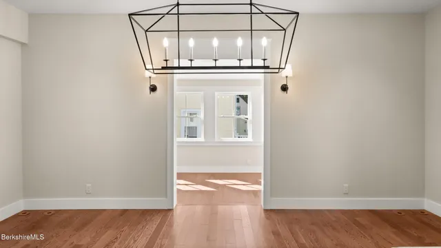 an empty room with wooden floor and door