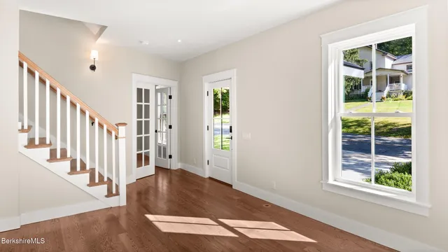 a view of an entryway with wooden floor