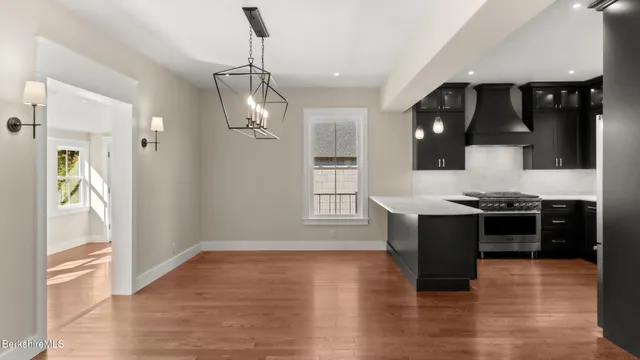 a kitchen with stainless steel appliances granite countertop a stove and a refrigerator