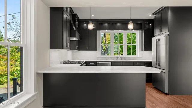 a kitchen with a sink and a large window