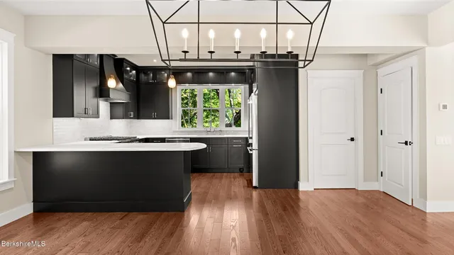 a kitchen with a refrigerator and a sink