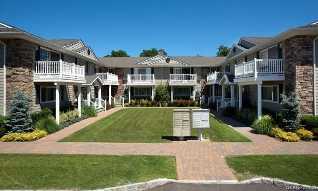 a front view of a house with a yard table and chairs
