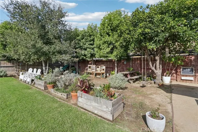 a view of a backyard with sitting area and garden