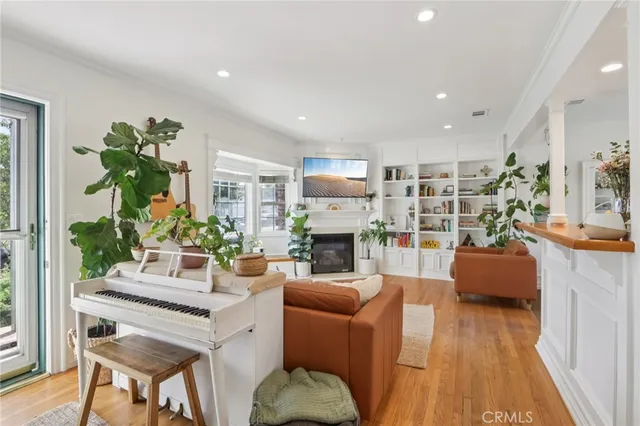 a living room with fireplace furniture and a wooden floor