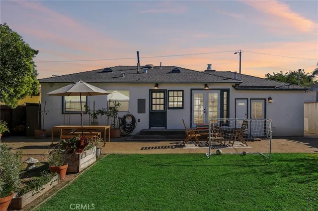 a front view of house with yard and outdoor seating