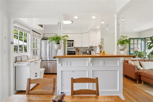 a kitchen with stainless steel appliances kitchen island granite countertop a refrigerator and a stove top oven