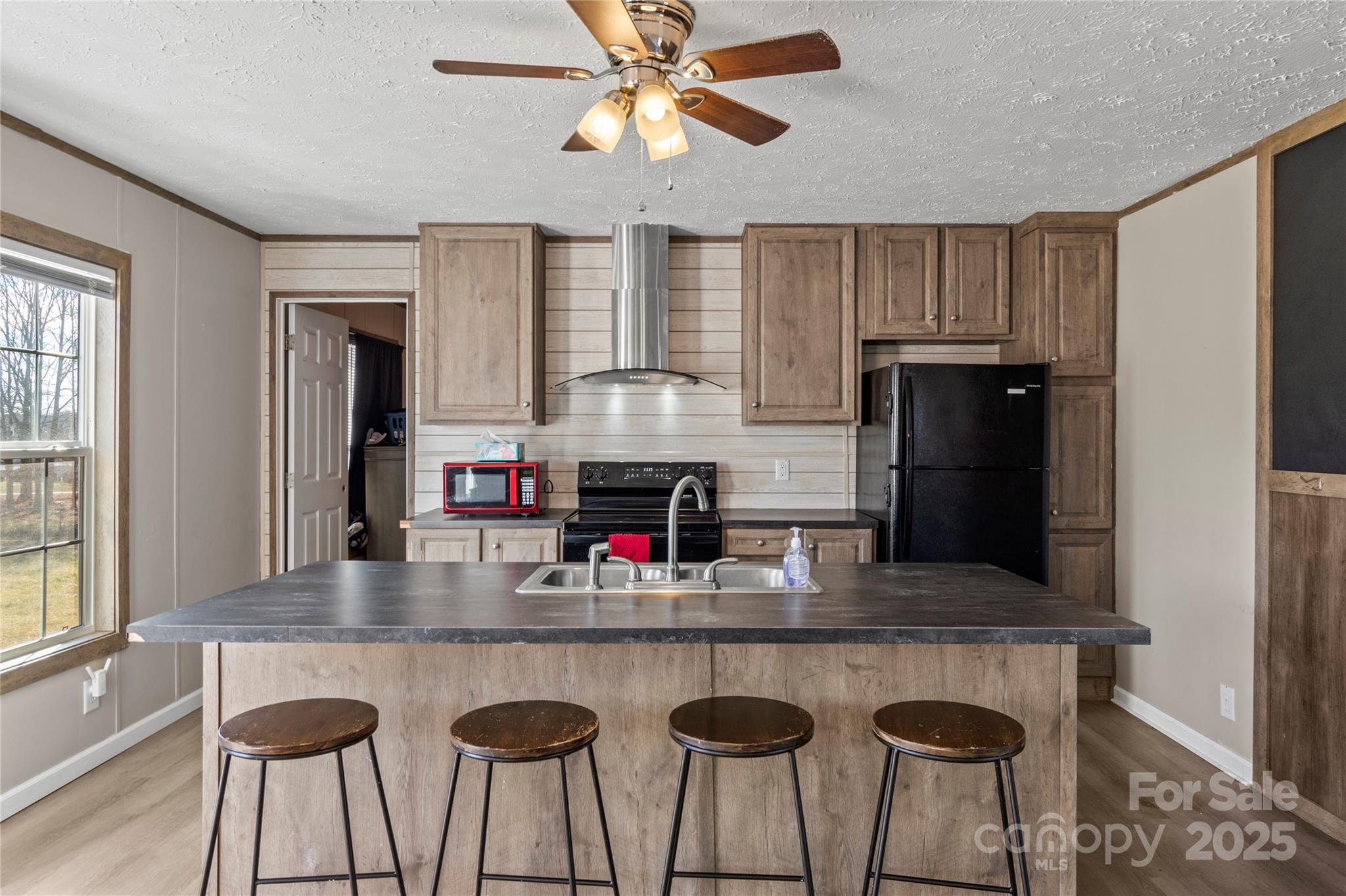 1079 Red Hill Creek Road Dobson, NC 27017 - Photo 11 of 28 a kitchen with granite countertop white cabinets and refrigerator