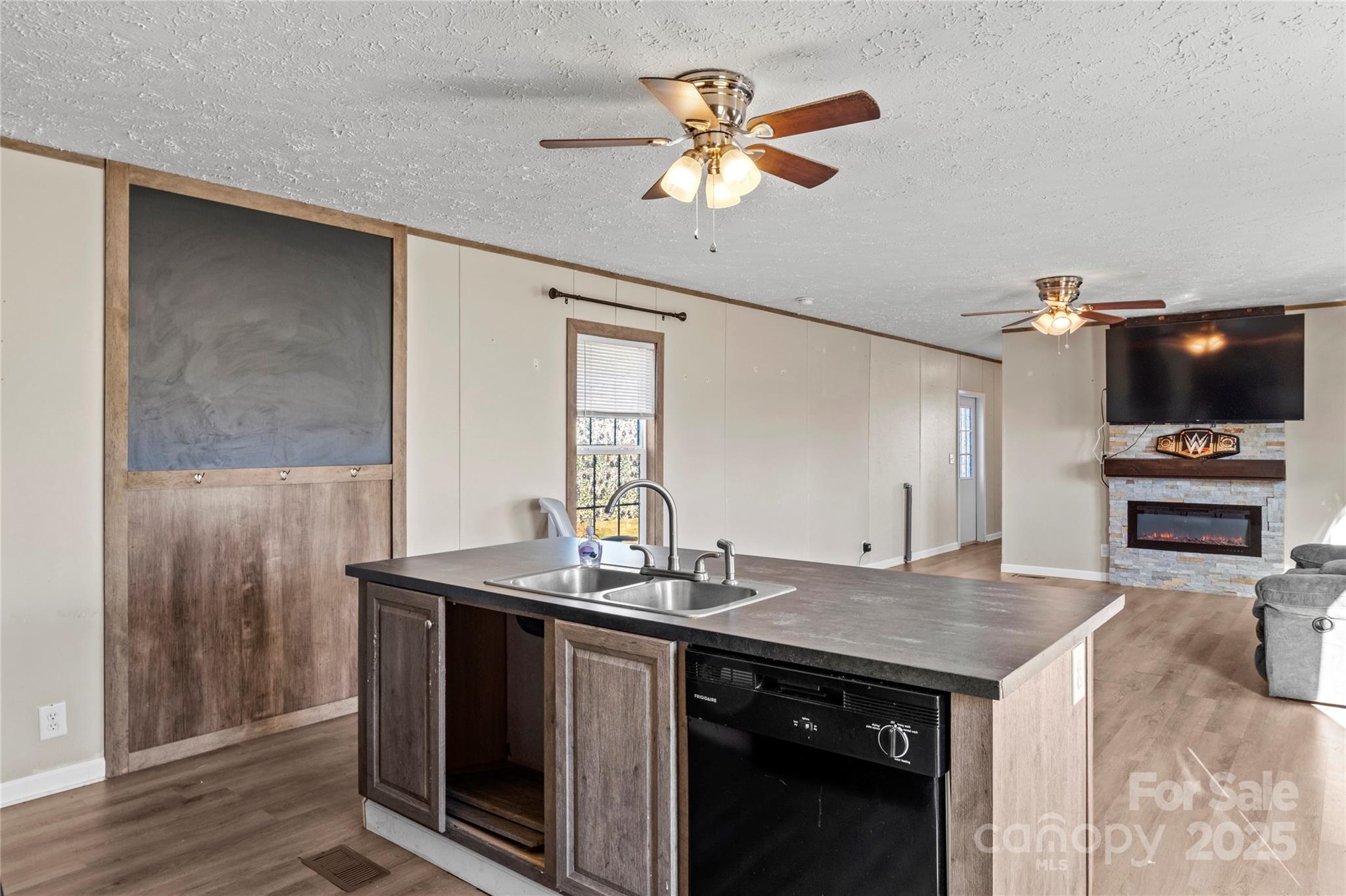 1079 Red Hill Creek Road Dobson, NC 27017 - Photo 12 of 28 a kitchen with a sink a stove and a refrigerator with wooden floor