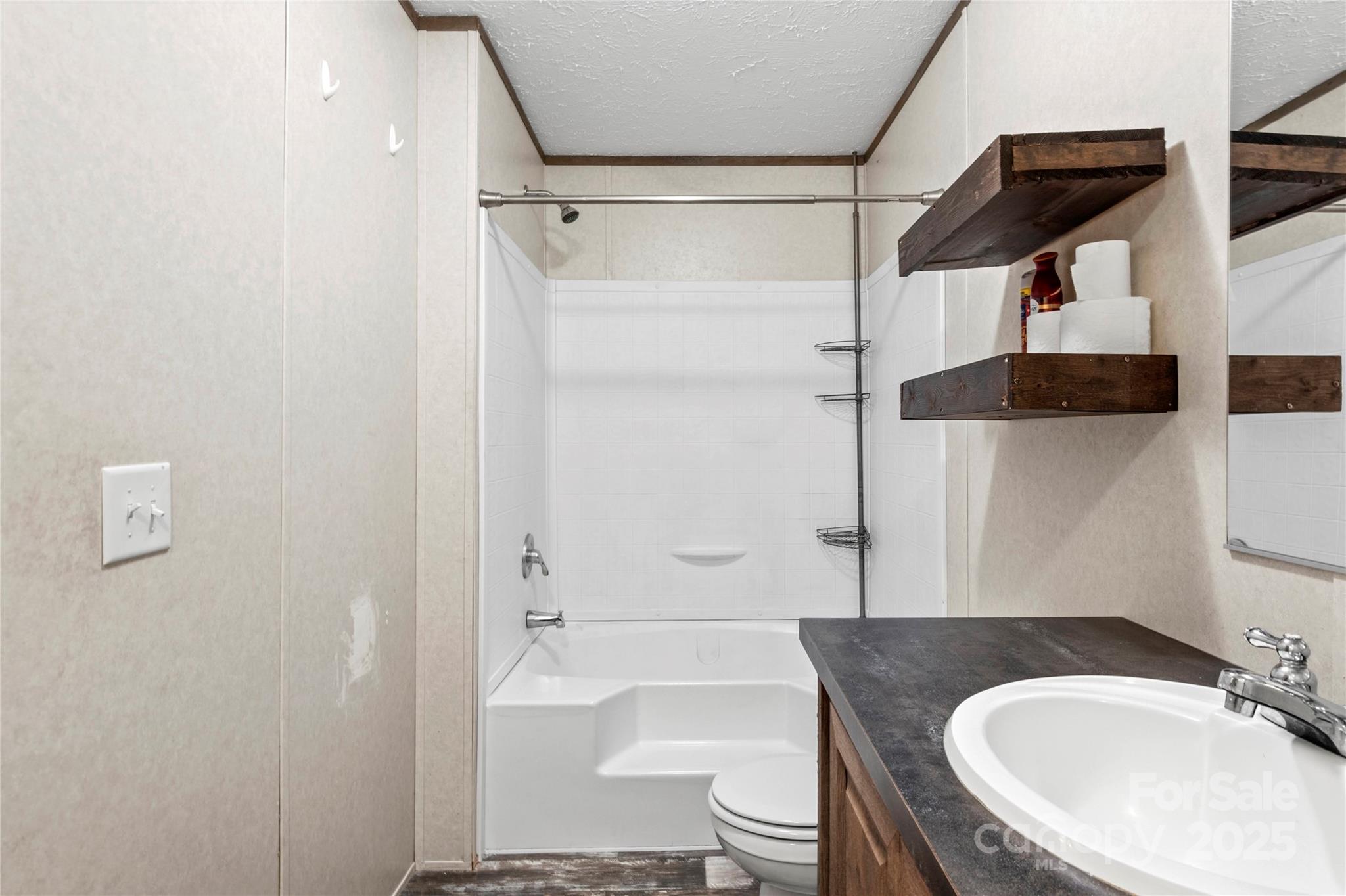 1079 Red Hill Creek Road Dobson, NC 27017 - Photo 15 of 28 a bathroom with a sink a toilet and shower