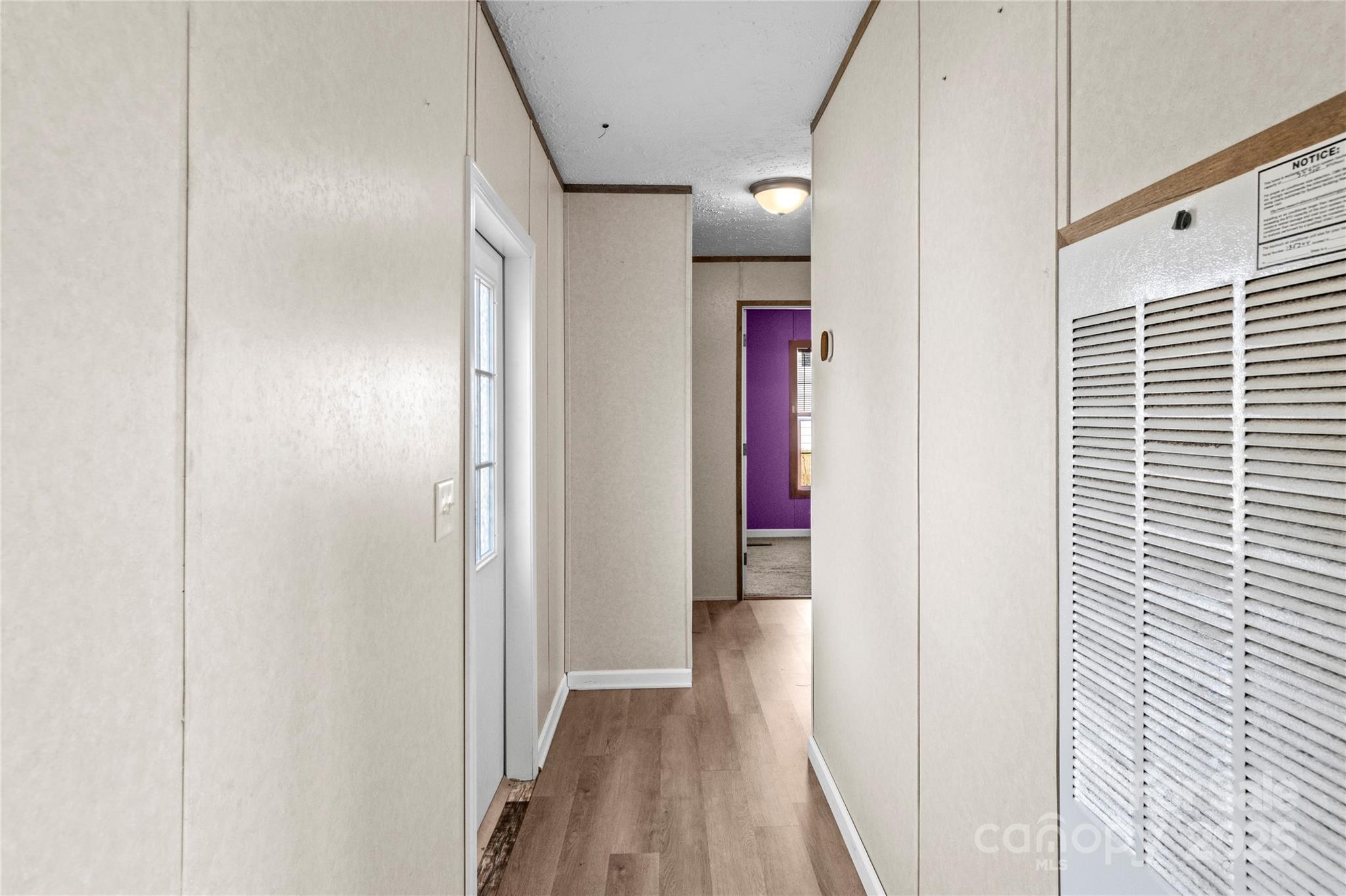 1079 Red Hill Creek Road Dobson, NC 27017 - Photo 17 of 28 a view of a hallway with wooden floor and closet