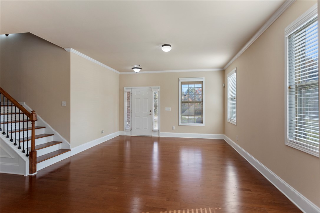 1005 Winmar Drive Anderson, SC 29621 - Photo 13 of 50 This inviting space features elegant hardwood flooring and a classic staircase, perfect for welcoming guests.