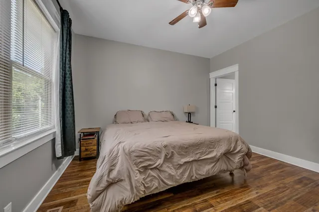 a bedroom with a bed and window