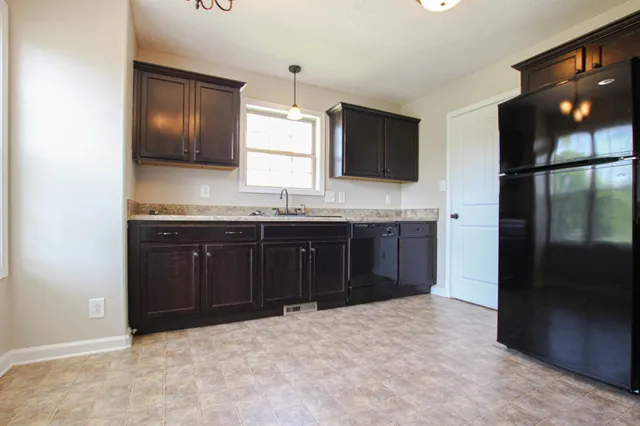 a kitchen with a sink and a refrigerator