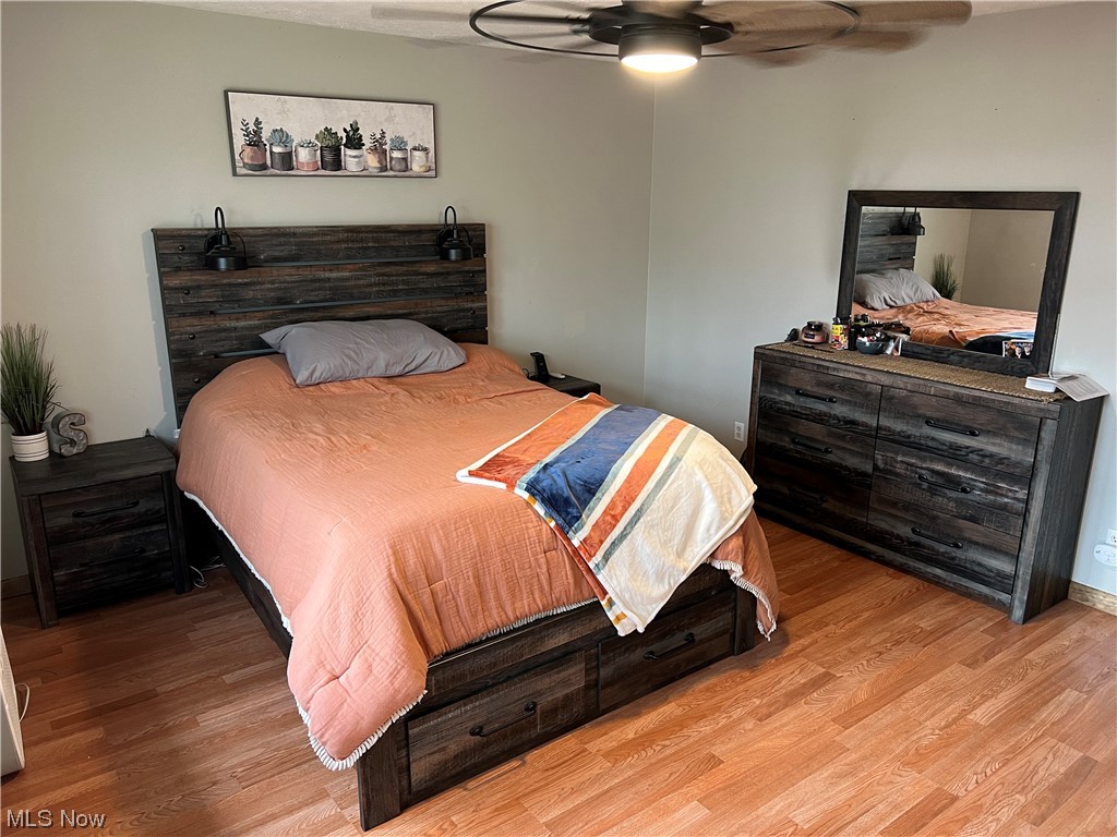 6950 Walker Road Walker, WV 26180 - Photo 8 of 22 Primary Bedroom with light hardwood / wood-style flooring and ceiling fan
