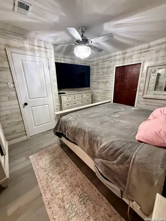 a bedroom with a bed and a flat screen tv