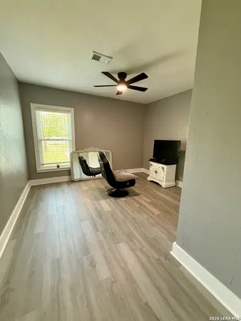 a bedroom with a bed and a ceiling fan