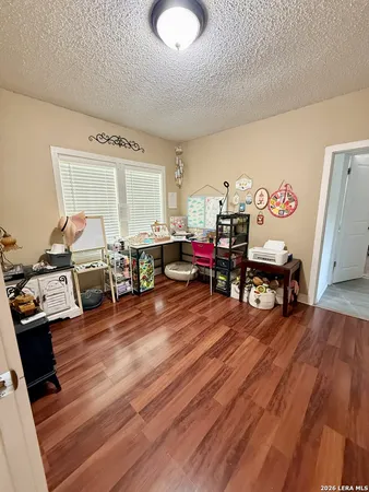 a living room with lots of furniture and a wooden floor