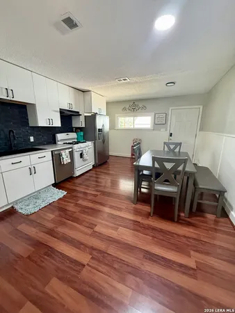a large kitchen with stainless steel appliances lots of counter top space