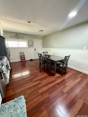 a view of a dining room with furniture and wooden floor