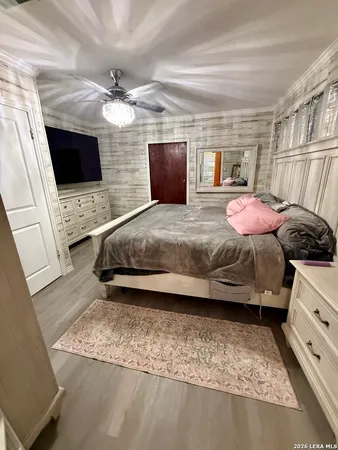 a bedroom with a bed and a flat screen tv