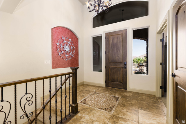 2005 West 450 S Circle St. George, UT 84770 - Photo 5 of 57 Grand entry foyer featuring tile flooring with an intricate medallion inlay, a dark wood entry door, and tall windows