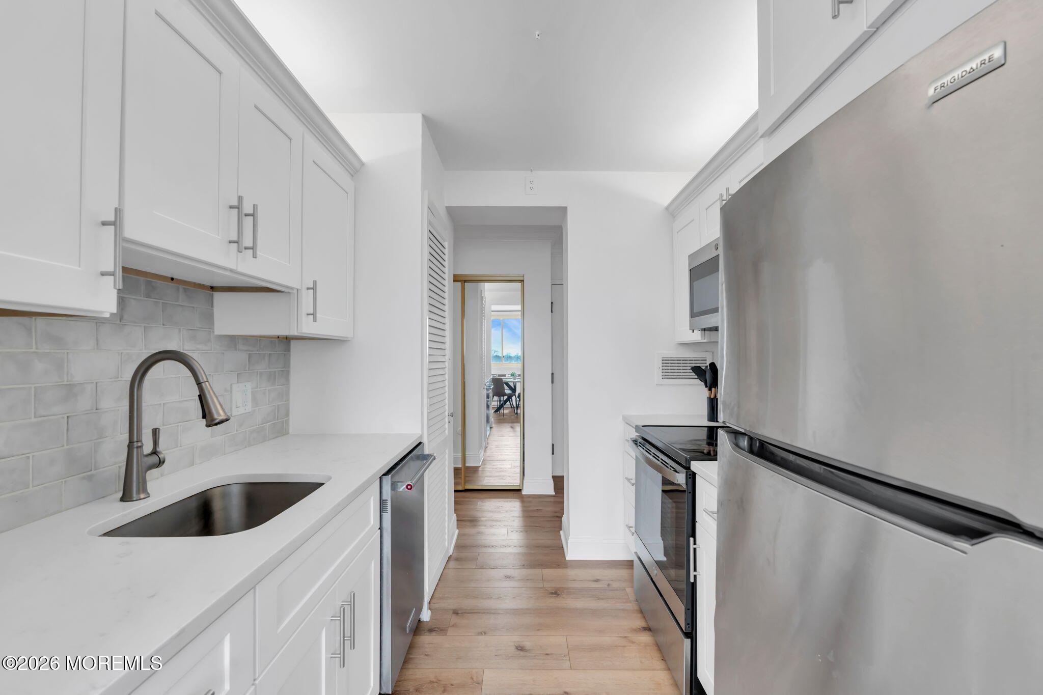 a kitchen with a refrigerator and a sink