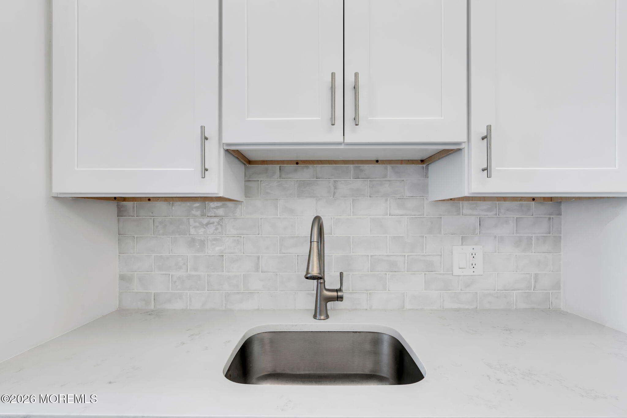 1000 River Road, Unit 7G Belmar, NJ 07719 - Photo 11 of 25 a kitchen with stainless steel appliances granite countertop white cabinets and a sink