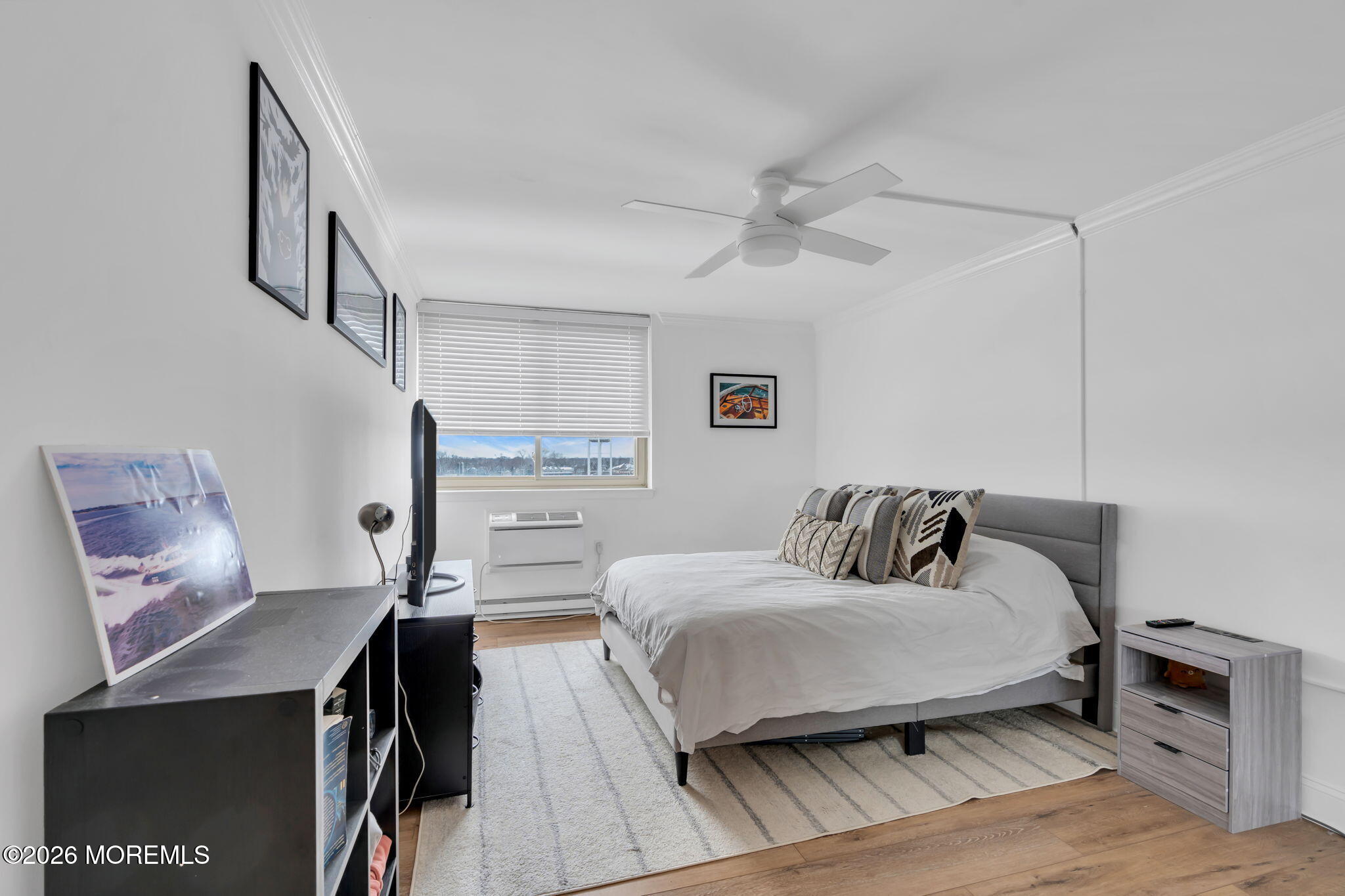 1000 River Road, Unit 7G Belmar, NJ 07719 - Photo 13 of 25 a bedroom with a bed and a chandelier