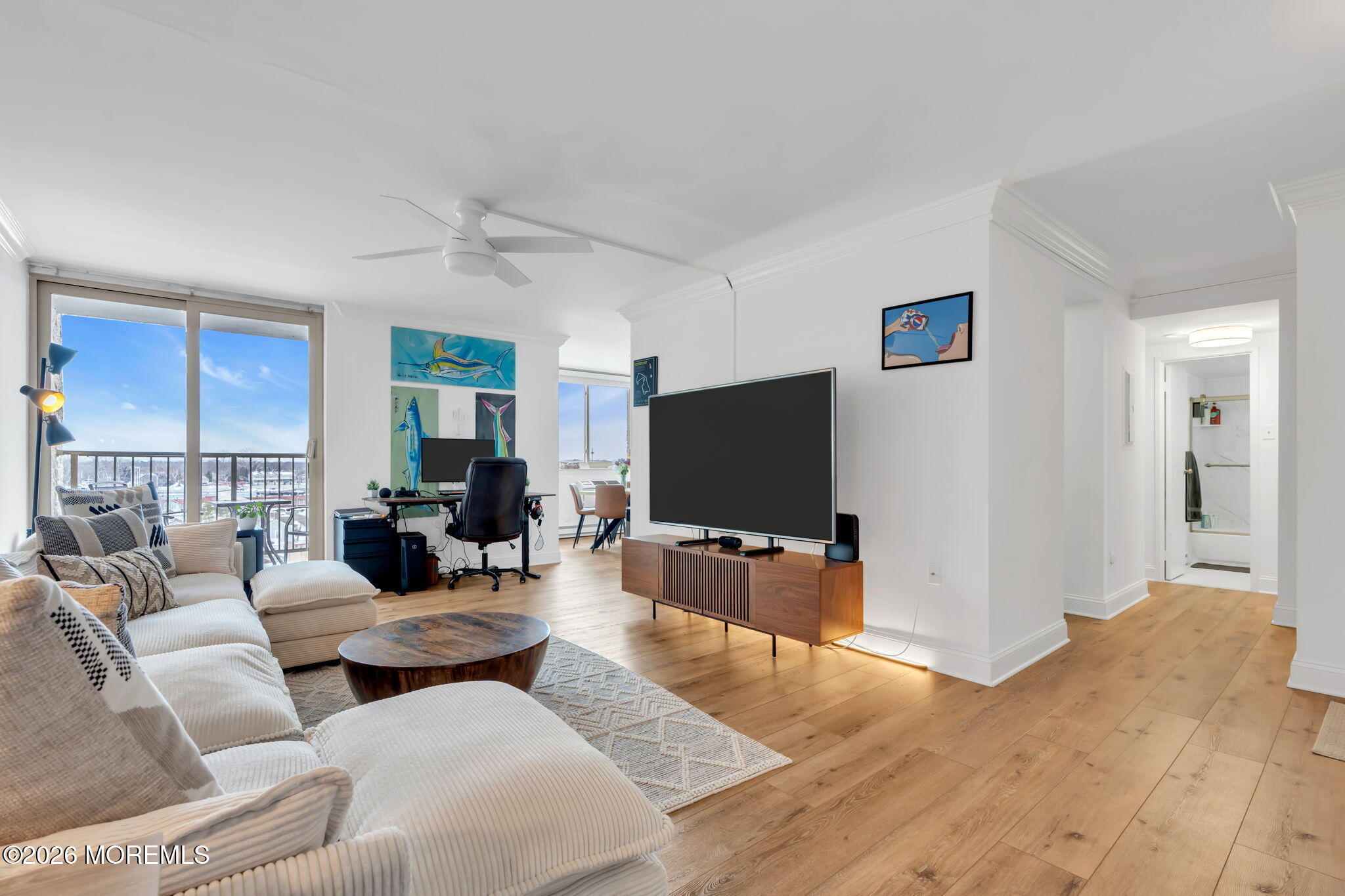 1000 River Road, Unit 7G Belmar, NJ 07719 - Photo 2 of 25 a living room with furniture and a flat screen tv