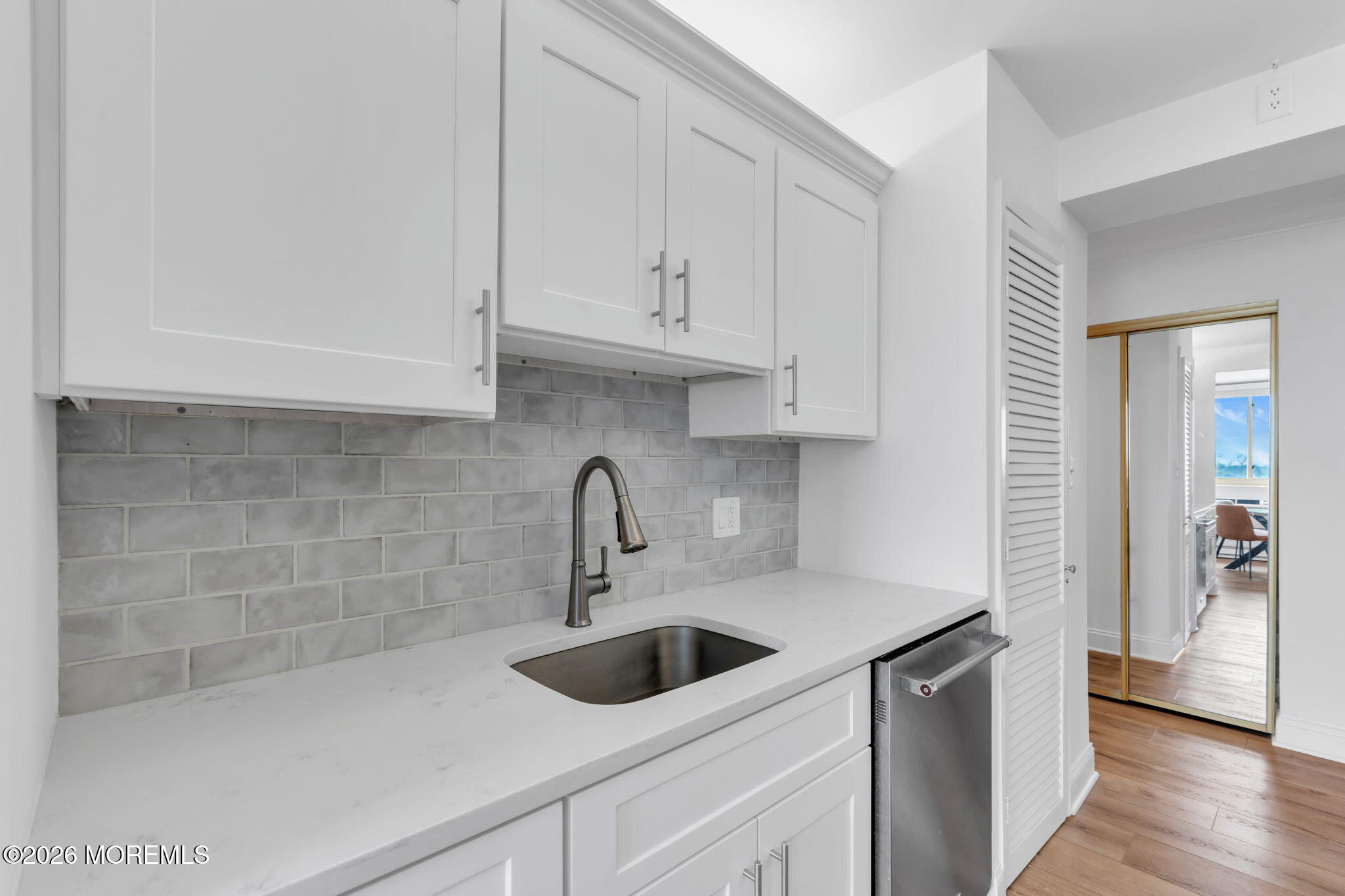 1000 River Road, Unit 7G Belmar, NJ 07719 - Photo 8 of 25 a kitchen with stainless steel appliances a sink a refrigerator and cabinets