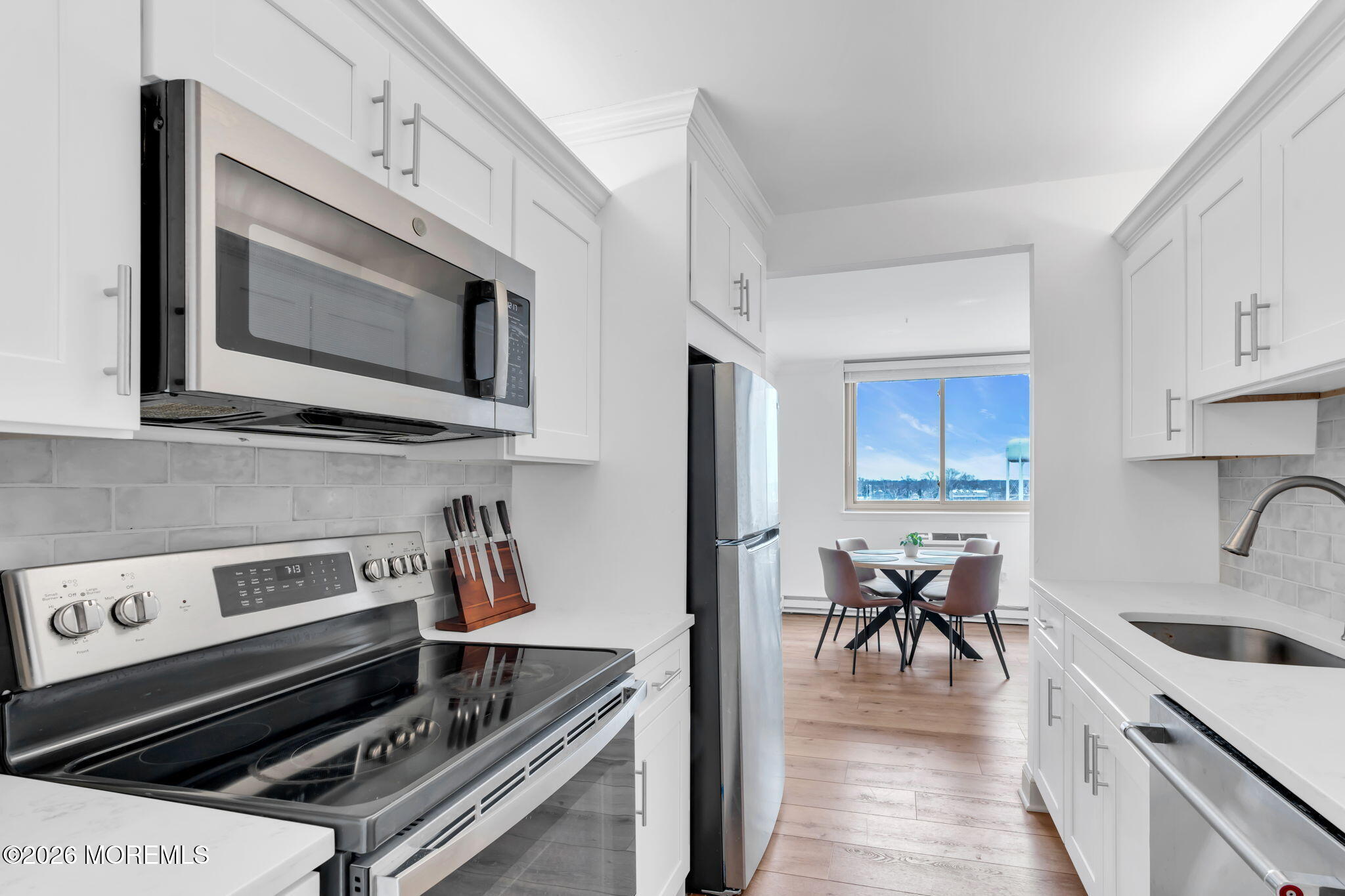 1000 River Road, Unit 7G Belmar, NJ 07719 - Photo 9 of 25 a kitchen with a stove a sink and a microwave