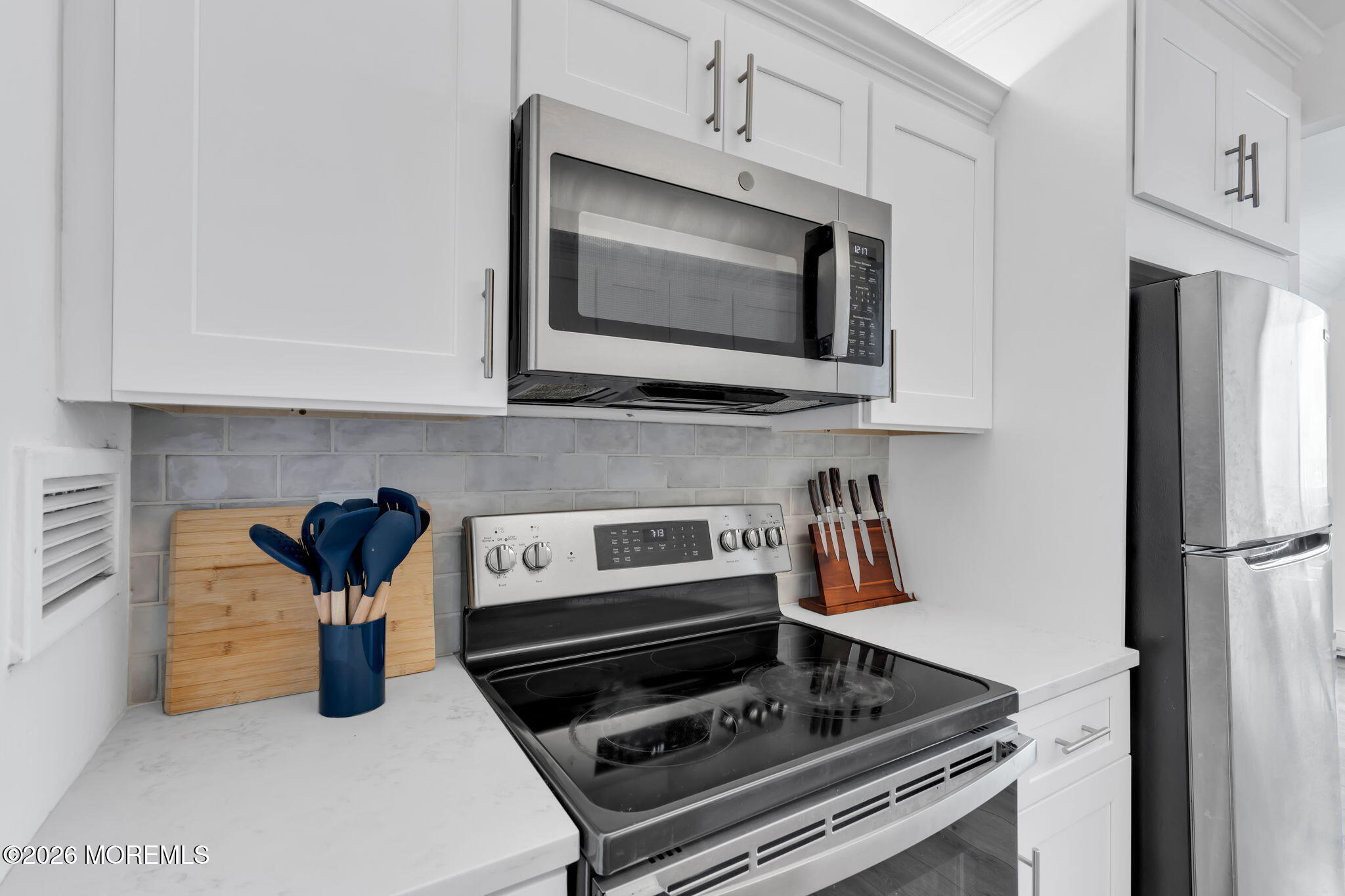 1000 River Road, Unit 7G Belmar, NJ 07719 - Photo 10 of 25 a kitchen with a stove and a microwave