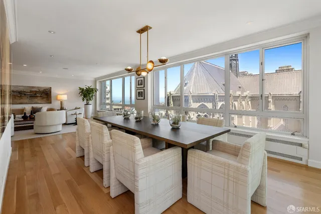 a very nice looking living room with a large window and wooden floor