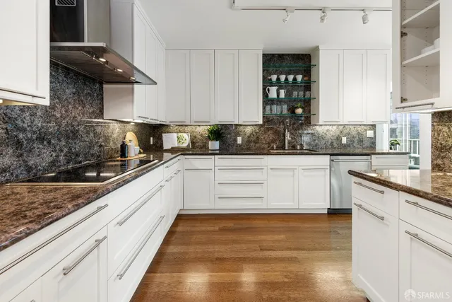 a kitchen with granite countertop white cabinets and white appliances