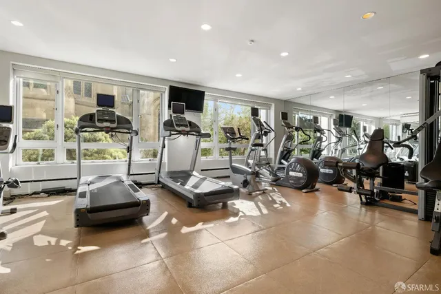 a room with gym equipment and a large window