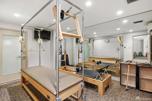 a room with table chairs and refrigerator