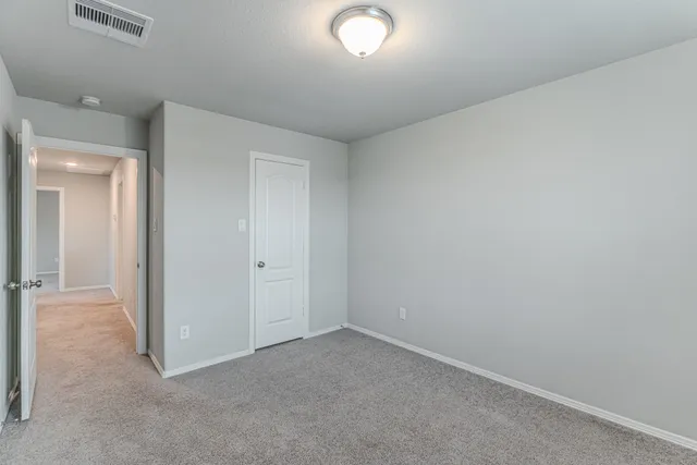 an empty room with closet area