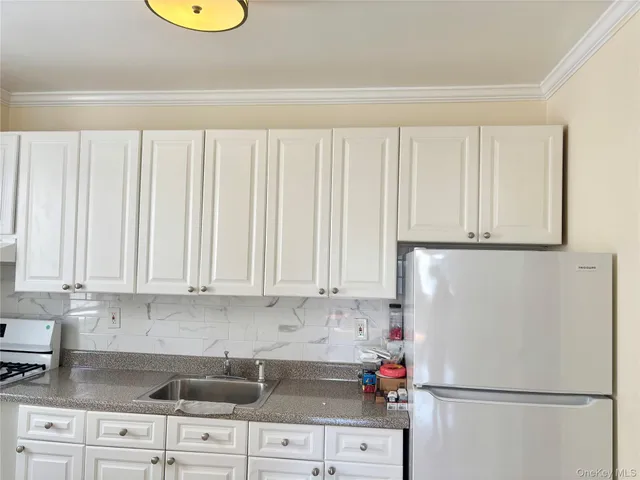 a white refrigerator freezer sitting inside of a kitchen