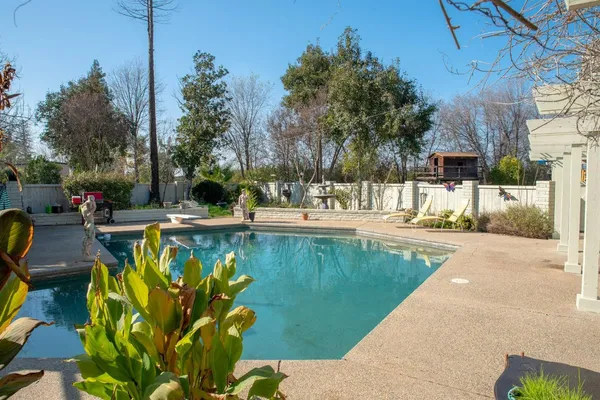 a swimming pool with outdoor seating and yard