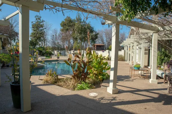 a view of a house with backyard porch and sitting area