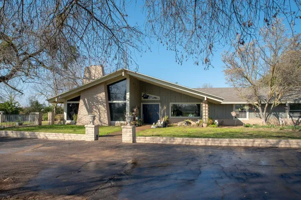 a living room with couches a flat screen tv and next to a window