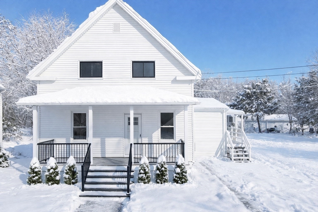 a view of a white house with a sink and yard