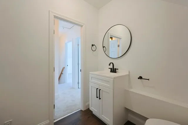 a bedroom with a bed and a flat screen tv in white walls