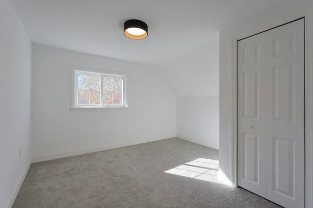 a bedroom with a bed and with furniture